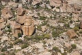 View from above of the ruins of an ancient temple in Hampi, India, with huge rocks and small tourists. Royalty Free Stock Photo