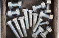 Top view of some big bolts, screws and nuts in the vintage box Royalty Free Stock Photo