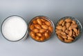 View from above of three glasses with dry, soaked almonds and with almonds milk. Showing ingredients needed to prepare almonds Royalty Free Stock Photo