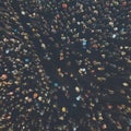 A view from above to the crowd of people gathering for an event. Crowed open-air meeting of people shot from a height. Night-time