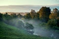 View from above to the small rural river at sunrise