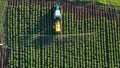 View from above of a tractor pulverizing fertilizer along the field