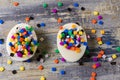 View from above of two eggs filled with colorful small mosaic