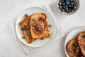 View from above of two plates with french toast with blueberries and a bowl of blueberries on a grey background, from above, Royalty Free Stock Photo