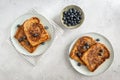 View from above of two plates with french toast with blueberries on a grey background, from above, minimalistic style Royalty Free Stock Photo