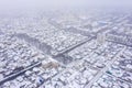 View from above of urban residential area during snowfall
