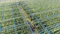 View from above of a warmhouse with green plantations. Industrial greenhouse from above, aerial view.