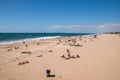 View from above the wide sandy beach of Huntington Beach California showing sunbathers swimmers and surfers