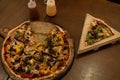 View from above of a wood oven pizza with mushrooms, meat and green and yellow peppers. Royalty Free Stock Photo