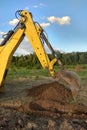 View from above at Working Excavator Tractor Digging A Trench. Royalty Free Stock Photo