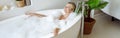 View from above on young beautiful female lying in warm bath, smiling and resting in spa. Royalty Free Stock Photo