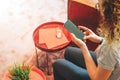 View from above. Young woman in glasses and striped T-shirt is sitting at home on couch and is using smartphone. Royalty Free Stock Photo