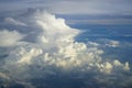 View of abstract dense soft fluffy white cloud with shades of blue sky and earth background from above flying plane window Royalty Free Stock Photo
