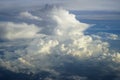View of abstract soft fluffy white cloud with shades of blue sky and earth background from above flying plane window Royalty Free Stock Photo