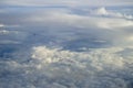 View of abstract soft white cloud shape with shades of blue sky background from above flying plane window Royalty Free Stock Photo