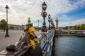 View across the Alexandre III Bridge with gilded statues and rows or ornate lamp in Paris
