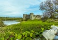 A view across a wall of the Carew River and the old castle in Pembrokeshire Royalty Free Stock Photo