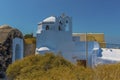 A view across the caste ruins towards a church bell tower in Pyrgos, Santorini