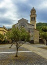 A view across the courtyard towards the striped church of Saint Andrea in the village of Levanto, Italy