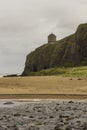 A view across Downhill beach in County Londonderry in Northern Ireland with a train heading toward the cliff tunnel Royalty Free Stock Photo