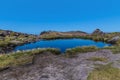 A view across Doxey Pool looking towards the cliff edge on the summit of the Roaches escarpment, Staffordshire, UK Royalty Free Stock Photo