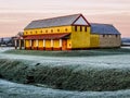 A view across the frost-covered fields at Wroxeter, UK towards the reconstructed Roman town house just before sunrise