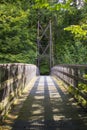 A view across the Inverted Bowstring Bridge across the Roe river in the Roe Valley country park near Limavady in County Londonderr Royalty Free Stock Photo