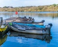 A view across a jetty with moored boats on Ravensthorpe Reservoir in Northamptonshire, UK