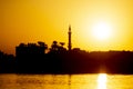 Landscape view of large river at sunset with minaret