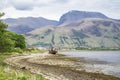 View across Loch Linnhe beyond an abandoned boat towards Ben Nevis Royalty Free Stock Photo