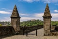 A far view of Stirling Castle through the entrance pillars of the Stirling Old Bridge. Royalty Free Stock Photo