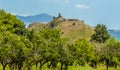 A view across an orchard to a hill top ruin in the foot hills of Mount Etna, Sicily Royalty Free Stock Photo