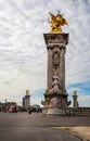 View across the ornate Alexander III Bridge spanning the Seine River and gilt bronze statues in Paris Royalty Free Stock Photo