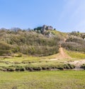 A view across the Pennard Pill stream floodplain towards the castle ruins at the Three Cliffs Bay, Gower Peninsula, South Wales Royalty Free Stock Photo