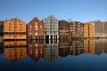 Colorful buildings along the quay in Trondheim, Norway, with a blue sky