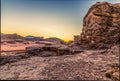 A view across the rocky terain of the desert landscape in Wadi Rum, Jordan at sunset Royalty Free Stock Photo