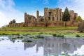 The view across a small lake on the `Great Mere`, Kenilworth, UK towards the ruins of the Kenilworth castle Royalty Free Stock Photo