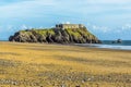 A view across the South Beach looking towards Saint Catherine`s Island in Tenby, Pembrokeshire at low tide Royalty Free Stock Photo