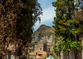 A view across a street in Taormina, Sicily towards the Castle Mola above the city Royalty Free Stock Photo