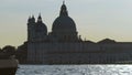 View from across wide river picturing immense cathedral with domes, slow motion