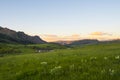 Early morning sun rising over with green fields, wild flowers, and a ranch in Colorado Royalty Free Stock Photo