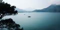 View on Adrasan Bay. Tourist boat in the sea. Aged photo.