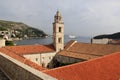 View of the Adriatic Sea over the red tiled roofs, Dominican monastery bell-tower in the forefront, Dubrovnik, Croatia Royalty Free Stock Photo