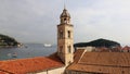 View of the Adriatic Sea over the red tiled roofs, Dominican monastery bell-tower in the forefront, Dubrovnik, Croatia Royalty Free Stock Photo