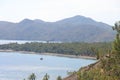 View of the Aegean Sea, mountains and rocks from the high shore near Marmaris, white sail and sailboat, Turkey, May 19 Royalty Free Stock Photo