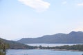 View of the Aegean Sea, mountains and rocks from the high shore near Marmaris, white sail and sailboat, Turkey, May 19 Royalty Free Stock Photo