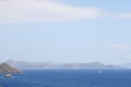 View of the Aegean Sea, mountains and rocks from the high shore near Marmaris, white sail and sailboat, Turkey, May 19 Royalty Free Stock Photo