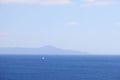 View of the Aegean Sea, mountains and rocks from the high shore near Marmaris, white sail and sailboat, Turkey, May 19 Royalty Free Stock Photo