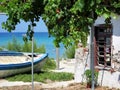 Old Fisherman Boat on land next to abandoned house in Greece, Halkidiki