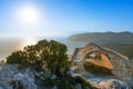 View of Aegean Sea, sunset and ruin of stone arch of Monolithos castle Rhodes, Greece